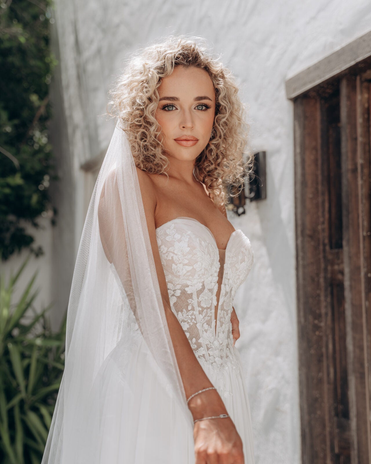 Bride in a white ivory wedding dress with a veil.