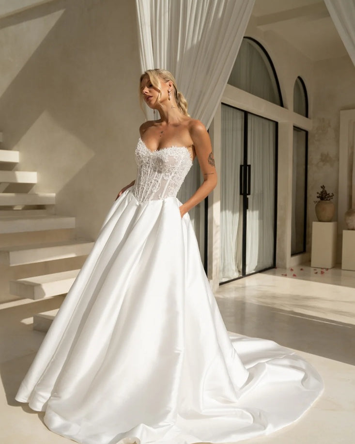 Princess style wedding dress with beaded bodice, full skirt and pockets