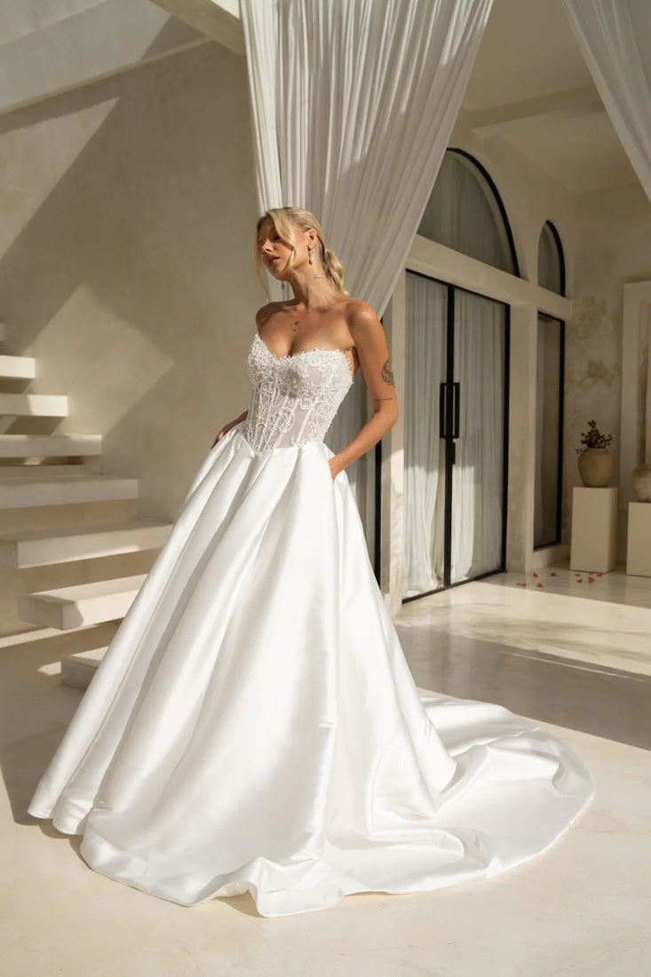 Princess style wedding dress with beaded bodice, full skirt and pockets