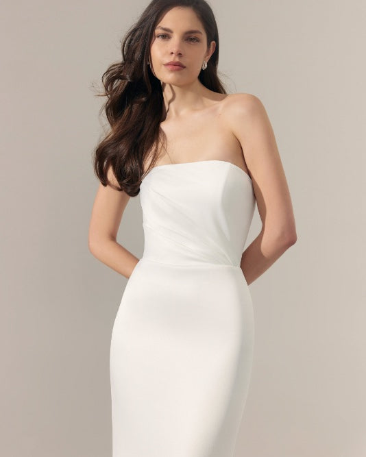 Strapless ivory satin wedding dress with straight across neckline.