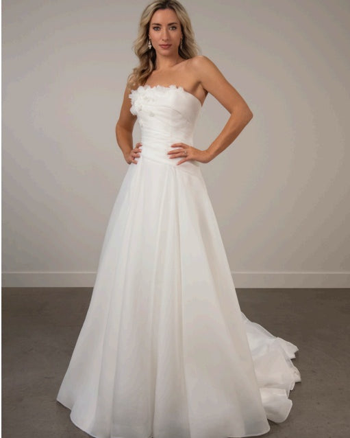 Bride wearing a strapless white ivory organza a-line wedding dress.