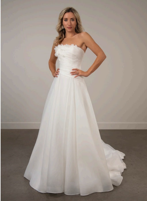 Bride wearing a strapless white ivory organza a-line wedding dress.