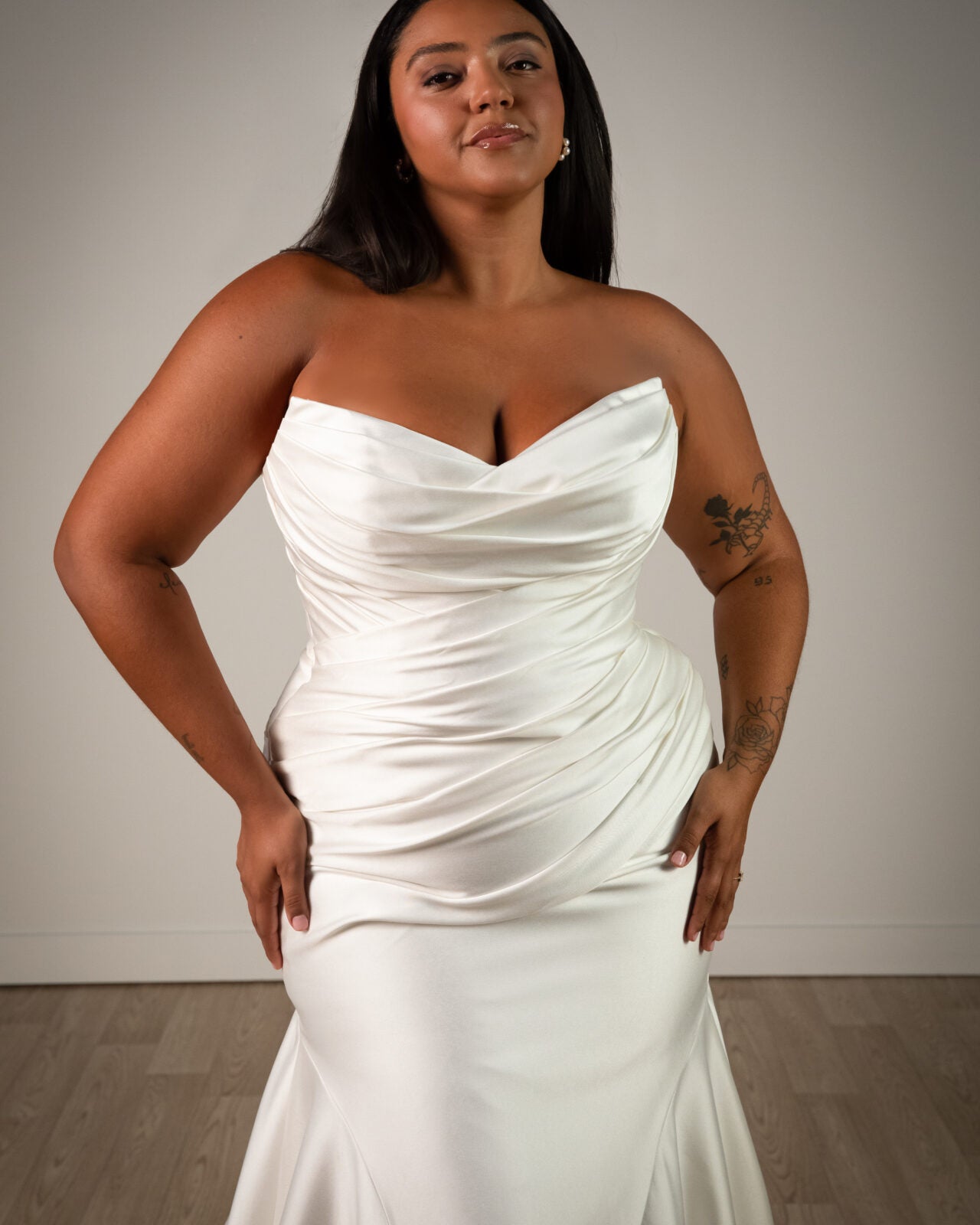 Stella York plus size wedding dress with strapless neckline, ruching and mermaid style train.