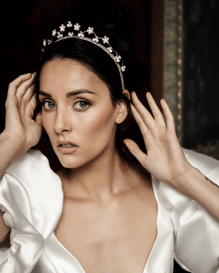 Woman wearing a bridal tiara with floral design.