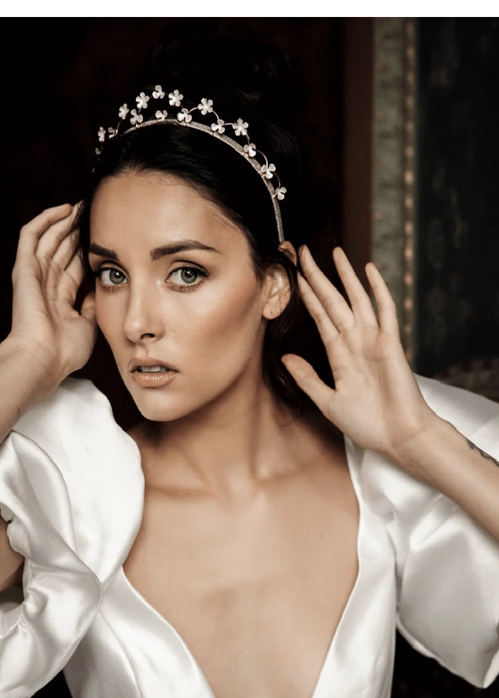 Woman wearing a bridal tiara with floral design.