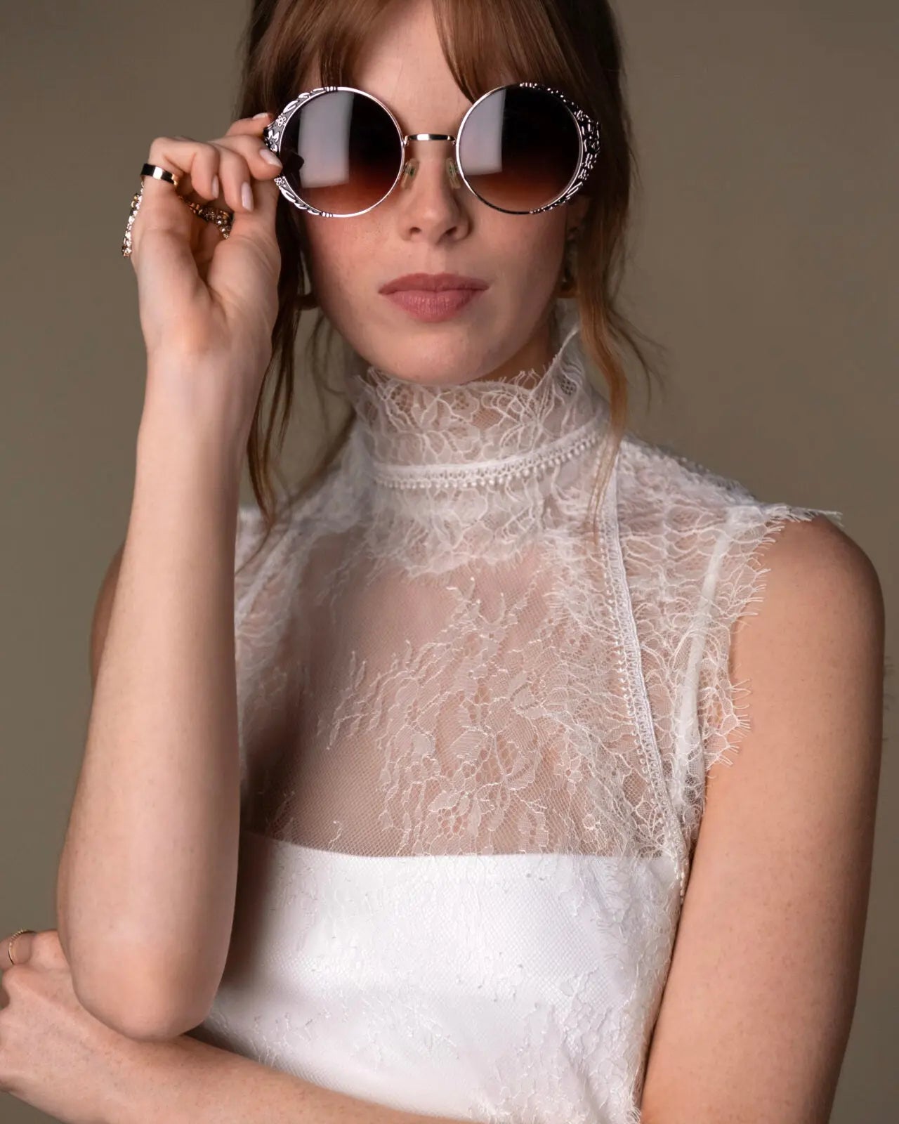 Lace and Charmeuse Sheath Wedding Dress with High Neckline and Keyhole Back. Delicate and effortless, the veda gown brings vintage romance to life with a relaxed, modern spirit. A layered two-piece look pairs an airy sandwashed charmeuse slip with a sheer lace overslip, creating soft texture and fluid movement in every step. The high neckline and slender straps lead to a striking keyhole back, while vintage-inspired lace trims and finishes give the gown unique charm.