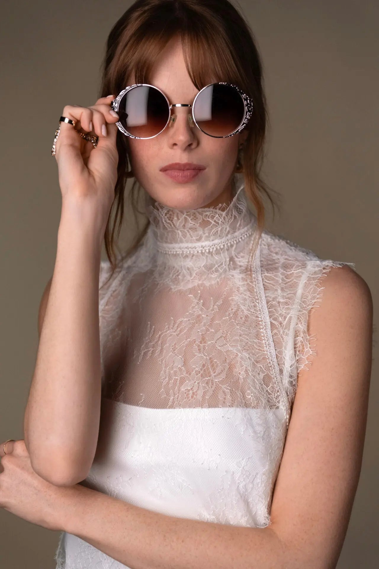 Lace and Charmeuse Sheath Wedding Dress with High Neckline and Keyhole Back. Delicate and effortless, the veda gown brings vintage romance to life with a relaxed, modern spirit. A layered two-piece look pairs an airy sandwashed charmeuse slip with a sheer lace overslip, creating soft texture and fluid movement in every step. The high neckline and slender straps lead to a striking keyhole back, while vintage-inspired lace trims and finishes give the gown unique charm.