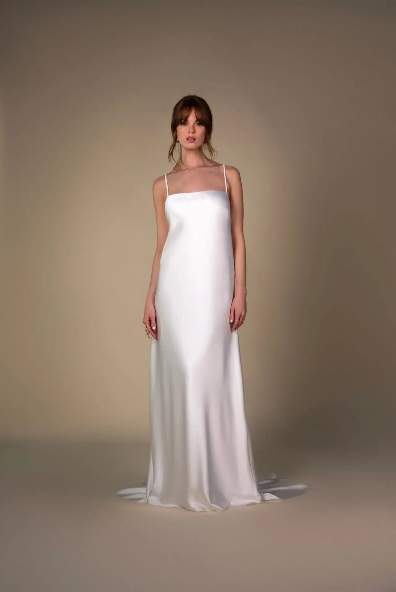 Lace and Charmeuse Sheath Wedding Dress with High Neckline and Keyhole Back. Delicate and effortless, the veda gown brings vintage romance to life with a relaxed, modern spirit. A layered two-piece look pairs an airy sandwashed charmeuse slip with a sheer lace overslip, creating soft texture and fluid movement in every step. The high neckline and slender straps lead to a striking keyhole back, while vintage-inspired lace trims and finishes give the gown unique charm.