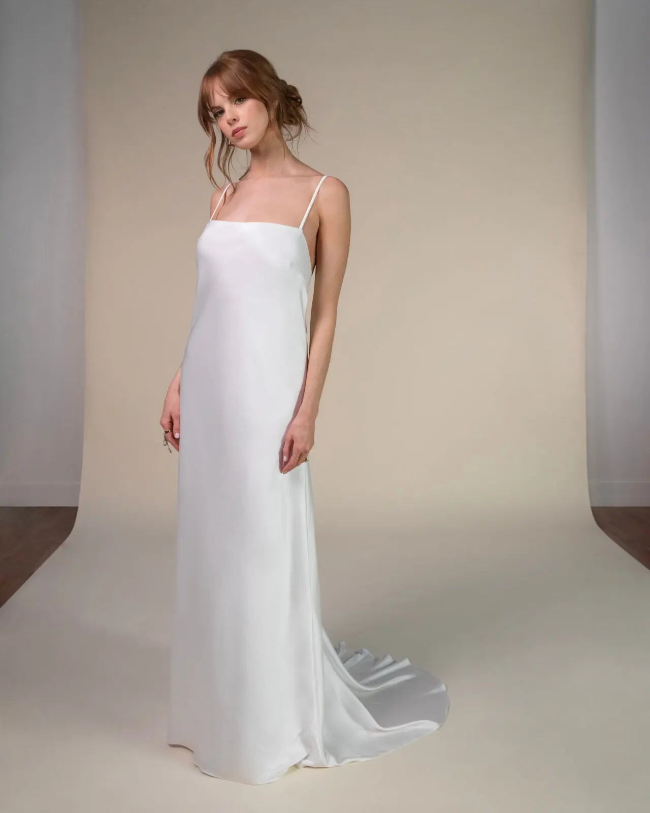 Lace and Charmeuse Sheath Wedding Dress with High Neckline and Keyhole Back. Delicate and effortless, the veda gown brings vintage romance to life with a relaxed, modern spirit. A layered two-piece look pairs an airy sandwashed charmeuse slip with a sheer lace overslip, creating soft texture and fluid movement in every step. The high neckline and slender straps lead to a striking keyhole back, while vintage-inspired lace trims and finishes give the gown unique charm.