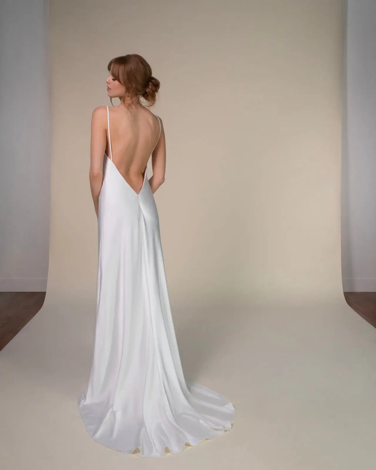 Lace and Charmeuse Sheath Wedding Dress with High Neckline and Keyhole Back. Delicate and effortless, the veda gown brings vintage romance to life with a relaxed, modern spirit. A layered two-piece look pairs an airy sandwashed charmeuse slip with a sheer lace overslip, creating soft texture and fluid movement in every step. The high neckline and slender straps lead to a striking keyhole back, while vintage-inspired lace trims and finishes give the gown unique charm.