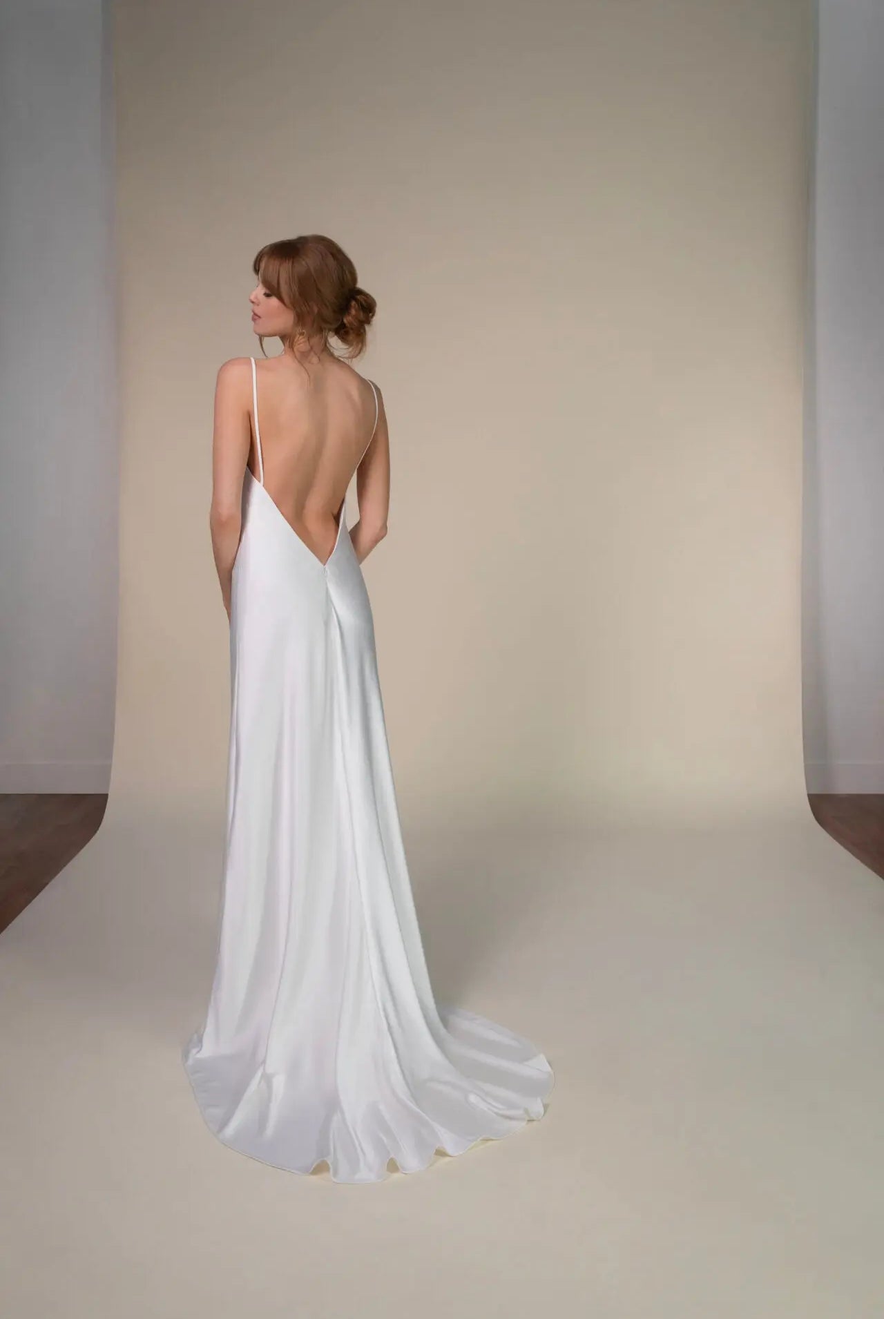 Lace and Charmeuse Sheath Wedding Dress with High Neckline and Keyhole Back. Delicate and effortless, the veda gown brings vintage romance to life with a relaxed, modern spirit. A layered two-piece look pairs an airy sandwashed charmeuse slip with a sheer lace overslip, creating soft texture and fluid movement in every step. The high neckline and slender straps lead to a striking keyhole back, while vintage-inspired lace trims and finishes give the gown unique charm.