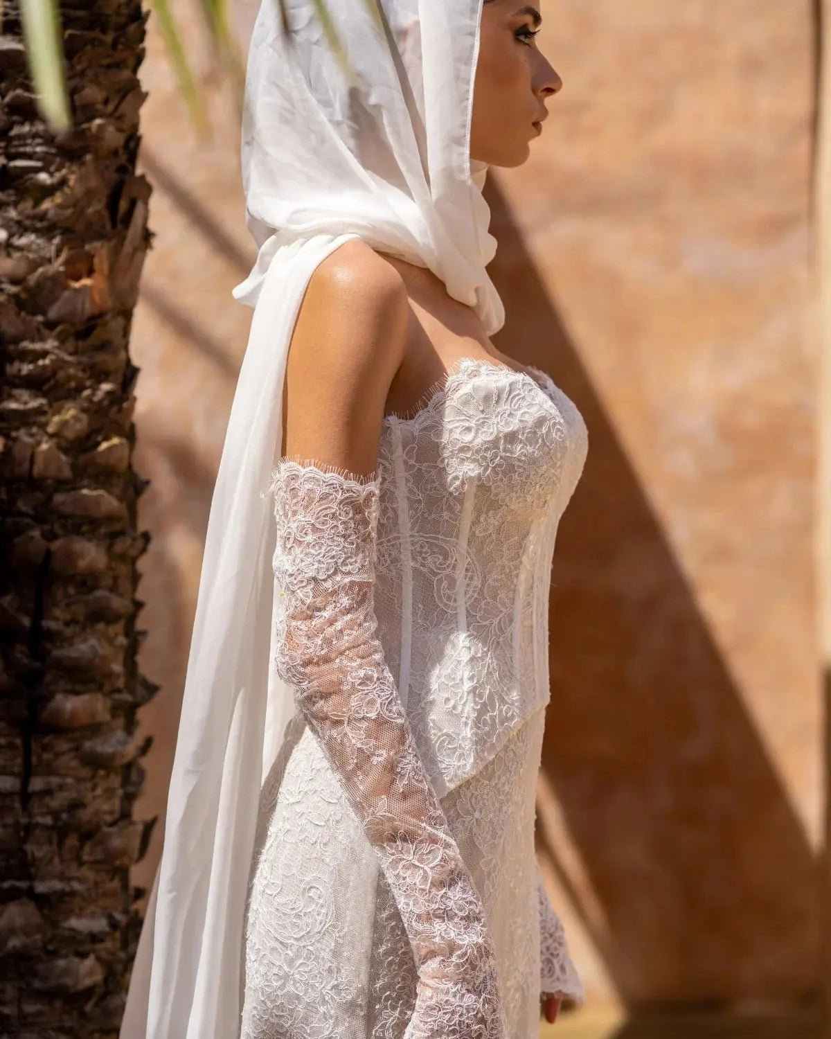 Side view of Amani two-piece lace wedding dress with sculpted fit-and-flare silhouette.