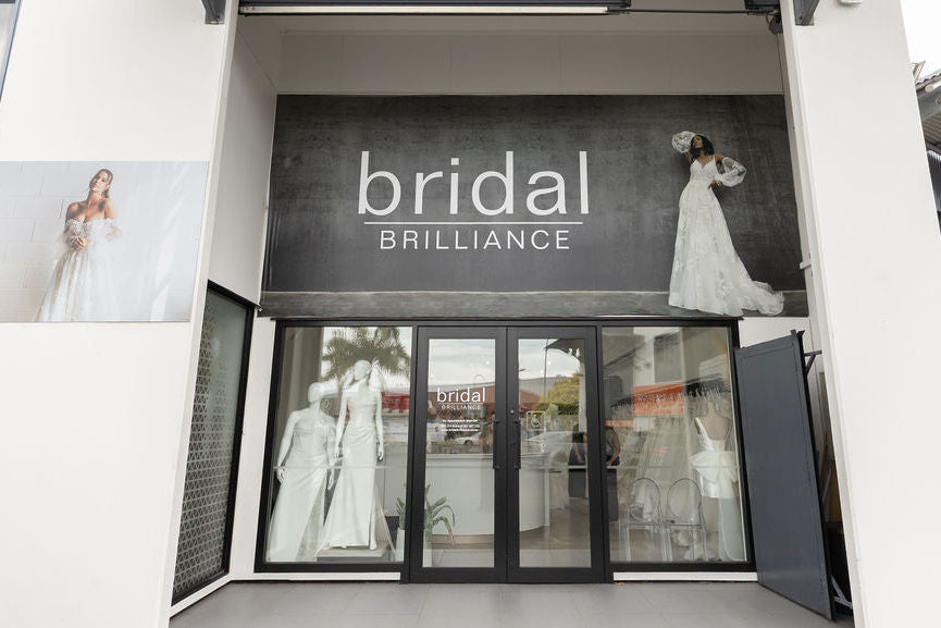 Bridal Brilliance store entrance with mannequins wearing wedding dresses.