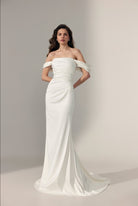 An elegant off-the-shoulder floor-length wedding gown in ivory satin fabric with off shoulder straps.