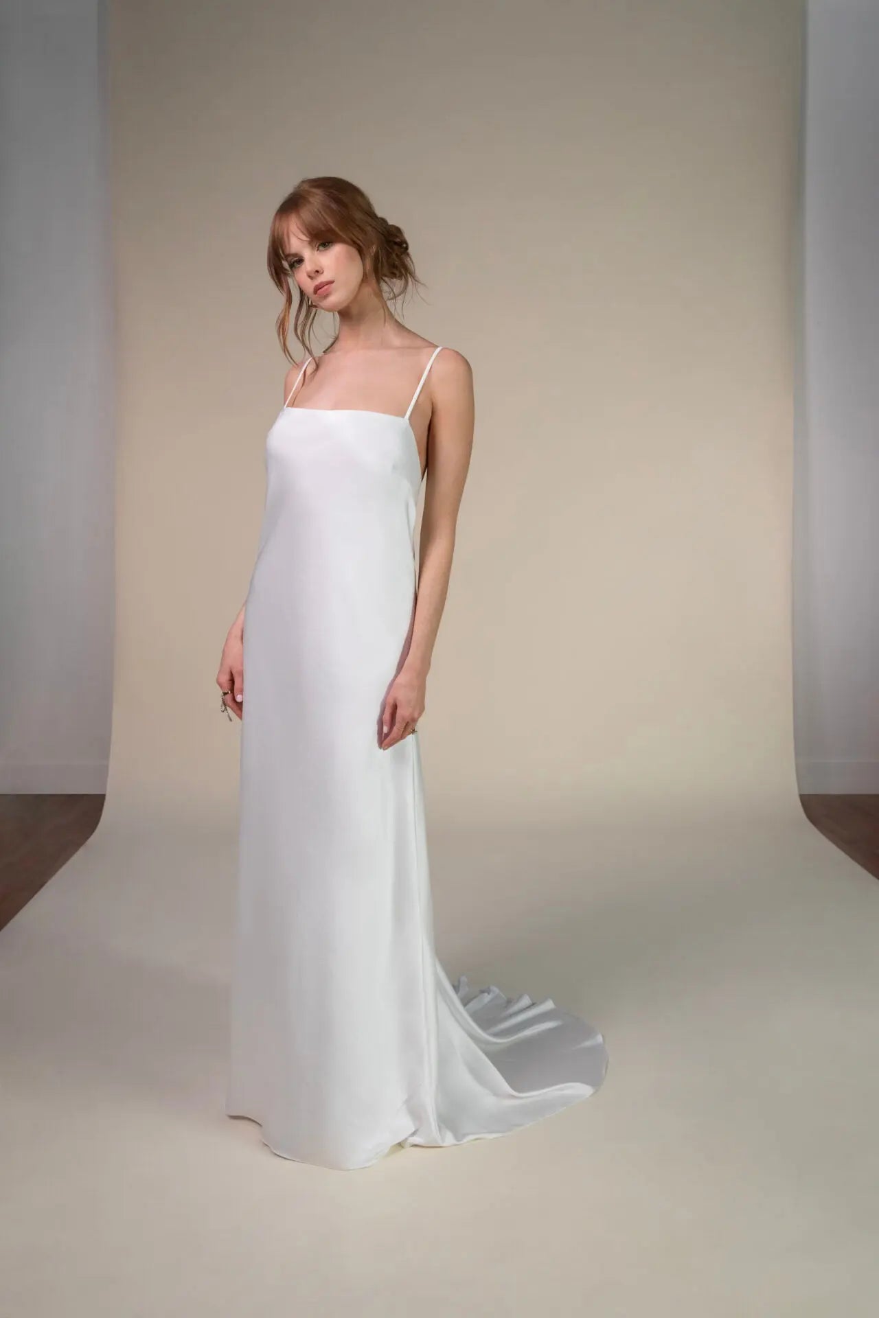 Lace and Charmeuse Sheath Wedding Dress with High Neckline and Keyhole Back. Delicate and effortless, the veda gown brings vintage romance to life with a relaxed, modern spirit. A layered two-piece look pairs an airy sandwashed charmeuse slip with a sheer lace overslip, creating soft texture and fluid movement in every step. The high neckline and slender straps lead to a striking keyhole back, while vintage-inspired lace trims and finishes give the gown unique charm.
