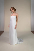 Lace and Charmeuse Sheath Wedding Dress with High Neckline and Keyhole Back. Delicate and effortless, the veda gown brings vintage romance to life with a relaxed, modern spirit. A layered two-piece look pairs an airy sandwashed charmeuse slip with a sheer lace overslip, creating soft texture and fluid movement in every step. The high neckline and slender straps lead to a striking keyhole back, while vintage-inspired lace trims and finishes give the gown unique charm.