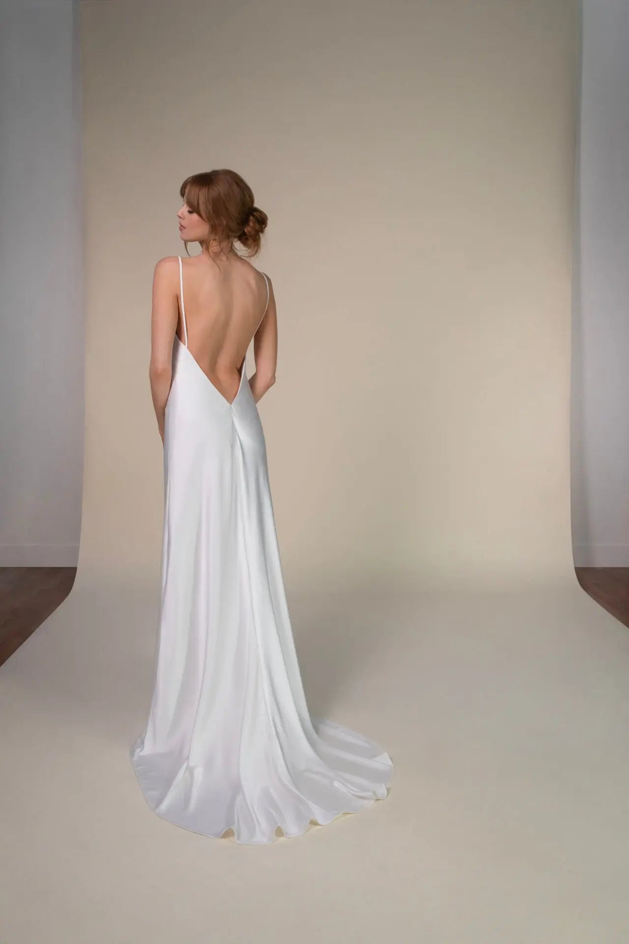 Lace and Charmeuse Sheath Wedding Dress with High Neckline and Keyhole Back. Delicate and effortless, the veda gown brings vintage romance to life with a relaxed, modern spirit. A layered two-piece look pairs an airy sandwashed charmeuse slip with a sheer lace overslip, creating soft texture and fluid movement in every step. The high neckline and slender straps lead to a striking keyhole back, while vintage-inspired lace trims and finishes give the gown unique charm.