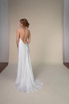 Lace and Charmeuse Sheath Wedding Dress with High Neckline and Keyhole Back. Delicate and effortless, the veda gown brings vintage romance to life with a relaxed, modern spirit. A layered two-piece look pairs an airy sandwashed charmeuse slip with a sheer lace overslip, creating soft texture and fluid movement in every step. The high neckline and slender straps lead to a striking keyhole back, while vintage-inspired lace trims and finishes give the gown unique charm.
