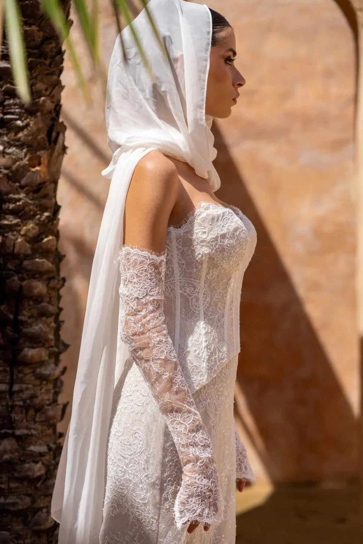 Side view of Amani two-piece lace wedding dress with sculpted fit-and-flare silhouette.