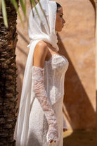 Side view of Amani two-piece lace wedding dress with sculpted fit-and-flare silhouette.